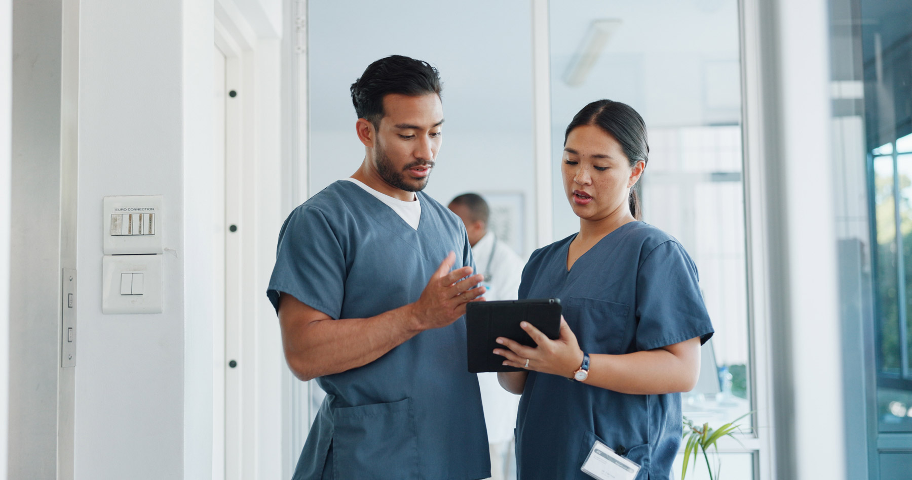 clinical-team-reviewing-patient-chart-on-tablet
