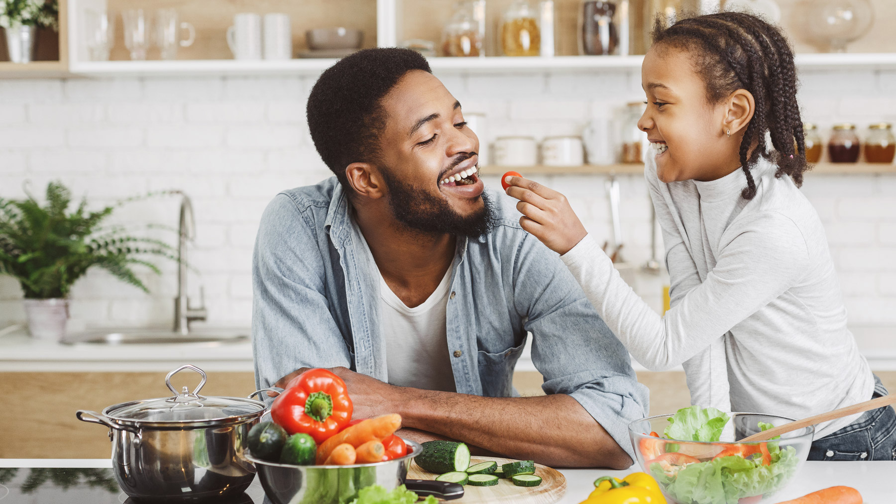 father-daughter-cooking-with-fresh-vegetables